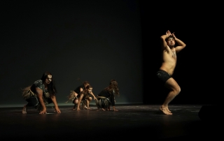 Indigenous man dancing in the likeness of a Kangaroo.